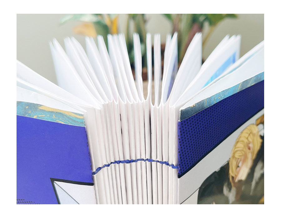 close-up of exposed spine of zine, with covers done in the butterfly style.